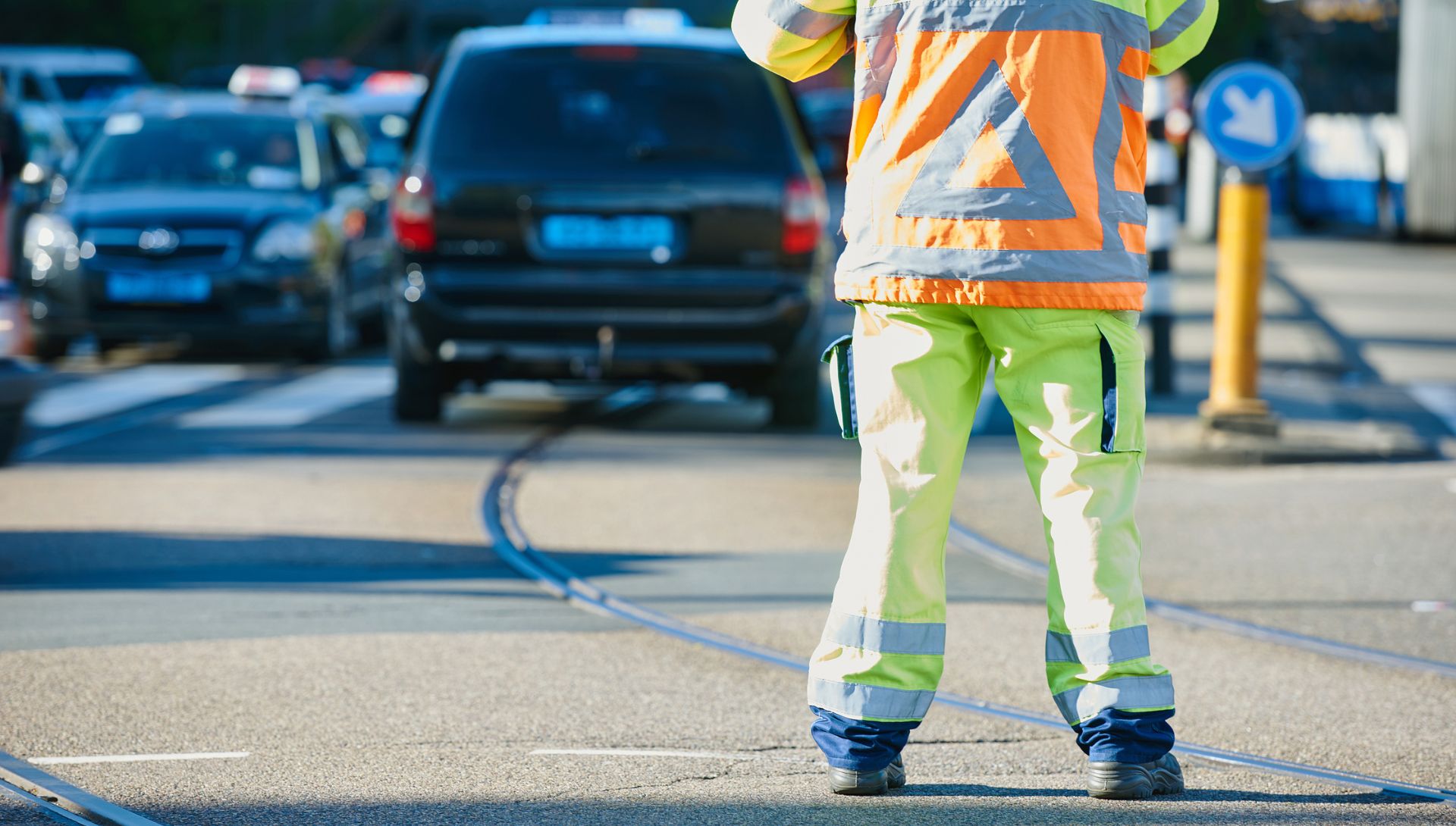 A shot from behind of a worker doing temporary traffic control