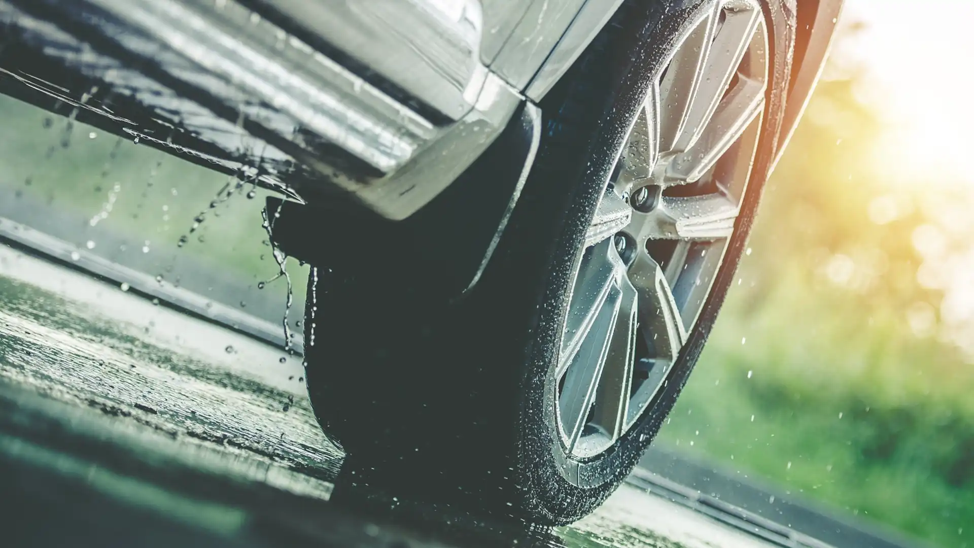 Road surface in wet conditions – car tire on a wet road